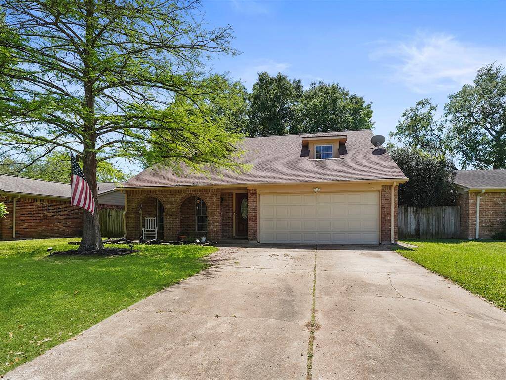 A stately, mature tree gracefully shades the front yard, creating a welcoming first impression. The attractive front porch is further enhanced by elegant arched brick accents, hinting at the character and comfort that awaits within.