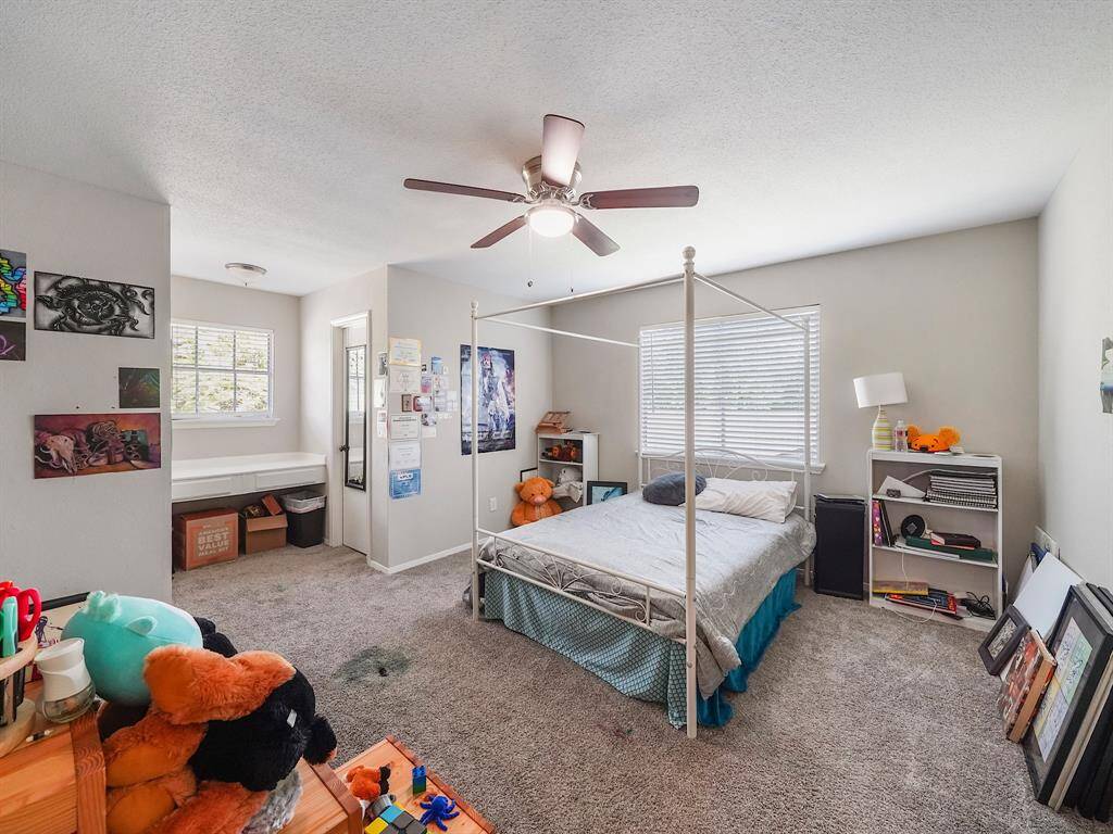 Bedroom #2 offers practicality and comfort with a built-in desk, perfect for studying or working from home, and a spacious closet for ample storage.