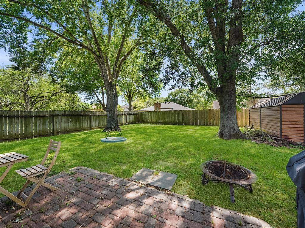 This charming property boasts an expansive backyard, perfect for entertaining, gardening, or simply relaxing under the shade of mature trees. A convenient storage shed keeps your outdoor essentials organized and out of sight. Imagine the possibilities!