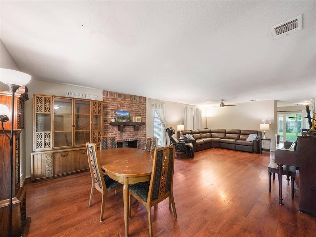 Welcome home to this charming residence! Step inside and be captivated by the expansive dining/living room, where a magnificent floor-to-ceiling fireplace commands attention. The spacious dining area provides the perfect setting for memorable gatherings.