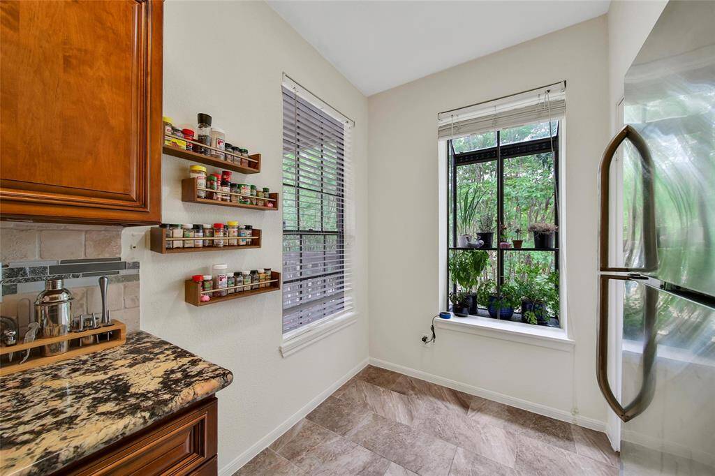 The breakfast room is ideal for a bistro table or a lounge chair to relax with a good book and cup of coffee. It features wall mounted spice racks and double windows to maximize natural light & tree lined views. One of the windows boasts a planter box to showcase herbs and flowers. This window also overlooks the community pool.