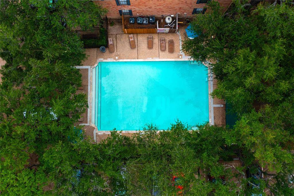 The community pool is visible from 196. Its location just across the street from the pool makes staying cool this summer a breeze! Note: this is an aerial view from a drone, not from unit 196 directly.