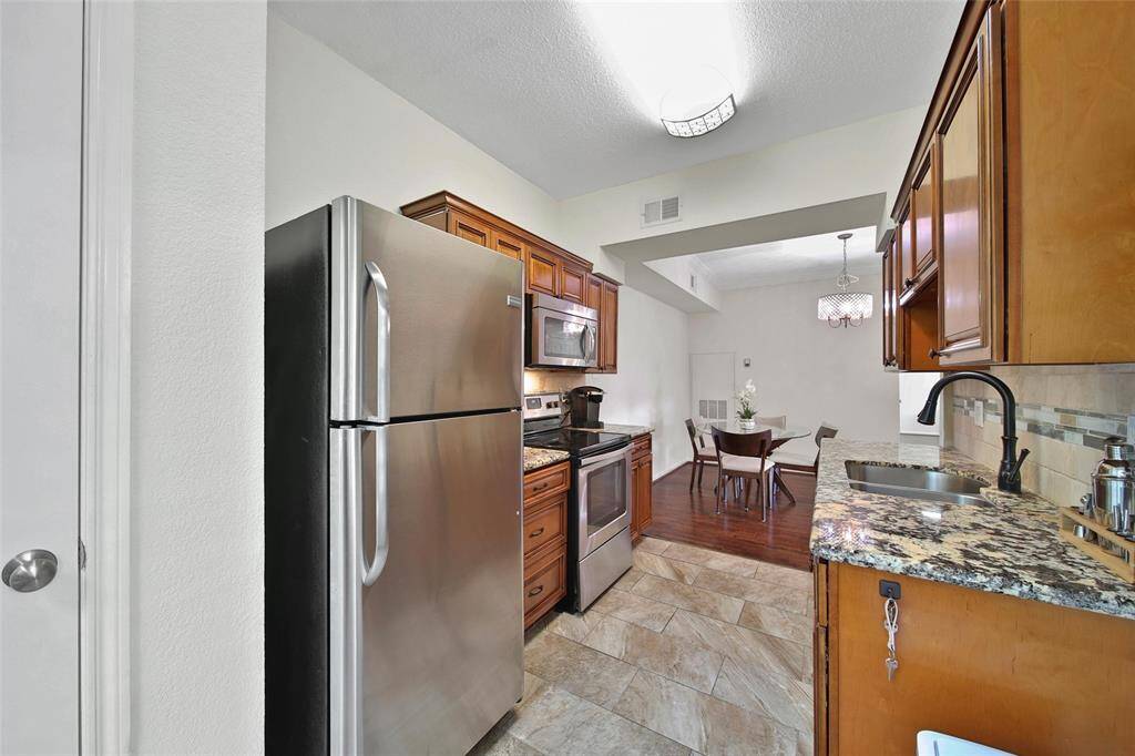 The kitchen offers a dedicated pantry for storage (to the far left in this photo).