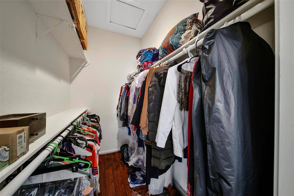 The primary closet is a large walk-in closet with ample space for storage with attic access above.