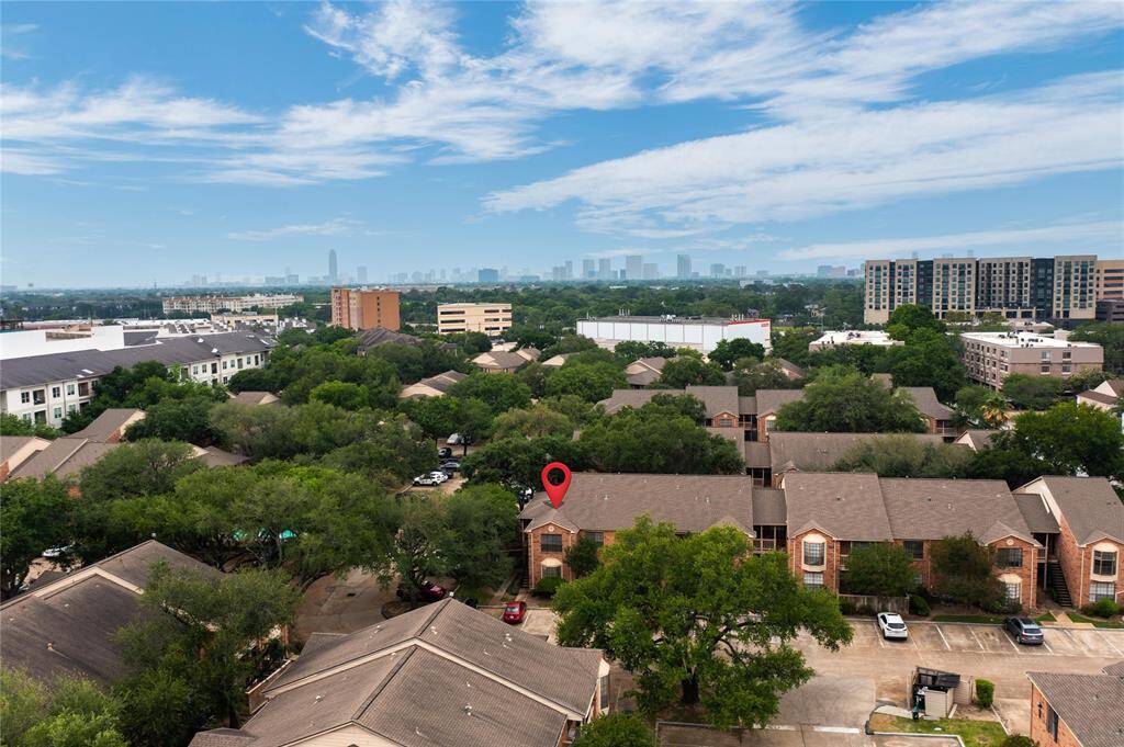 Tucked away beneath the trees behind a gated drive, yet with ample open parking all around and fantastic community amenities, Braeswood park is your oasis in the city with easy access to the TMC, Rice University, Galleria, Downtown and more. Just look at the city skyline behind the property.