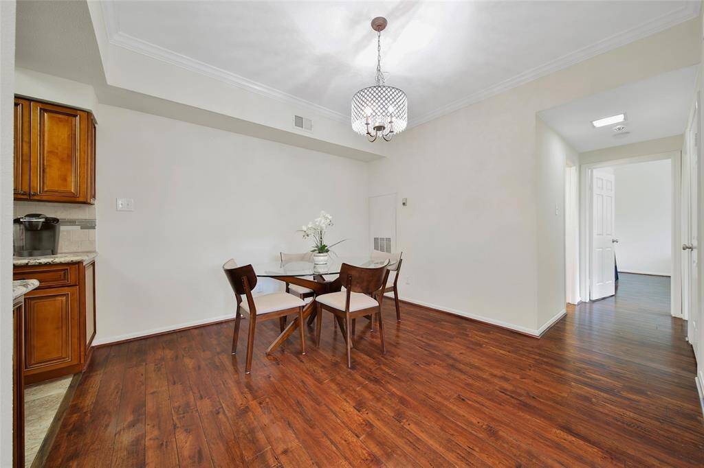 The dining room offers ample space for everything from daily meals to large gatherings. The neutral paint, crown molding and wood look flooring continues in this space for a seamless open flow.