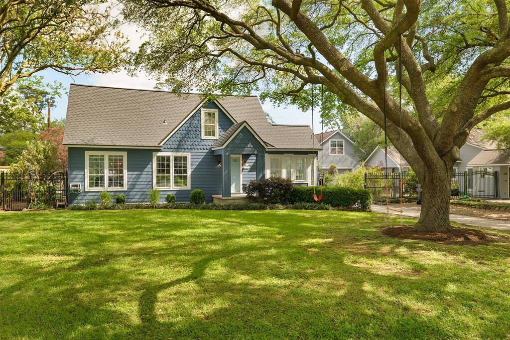 Charming Garden Oaks home with a stunning oak tree in front. A blend of classic and natural beauty.