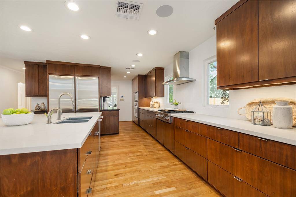 Spacious kitchen featuring a large island with an integrated sink.