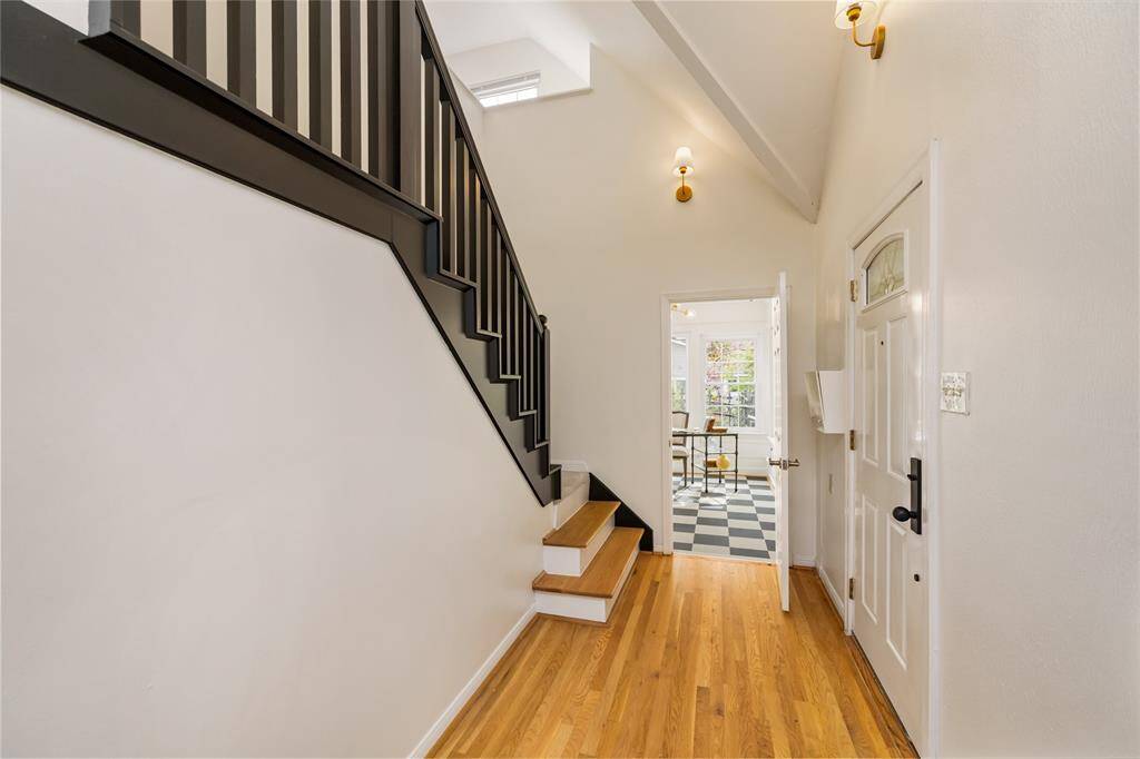 View from the front living room to the entry, staircase and sunroom