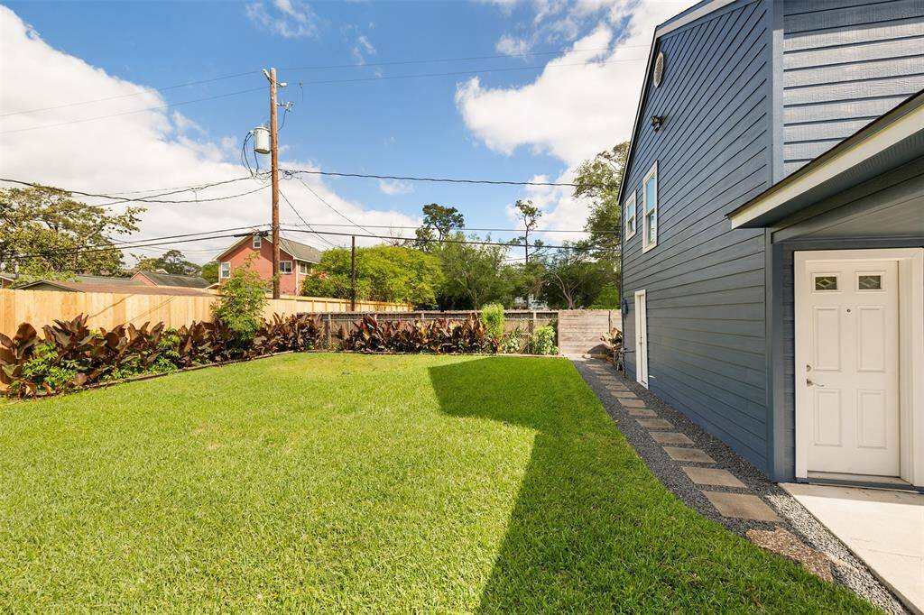 Spacious backyard with room for a pool and already has an outdoor open shower behind the garage