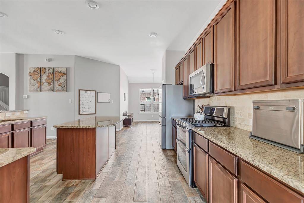 Huge kitchen with oversized island w/ a view of the breakfast area