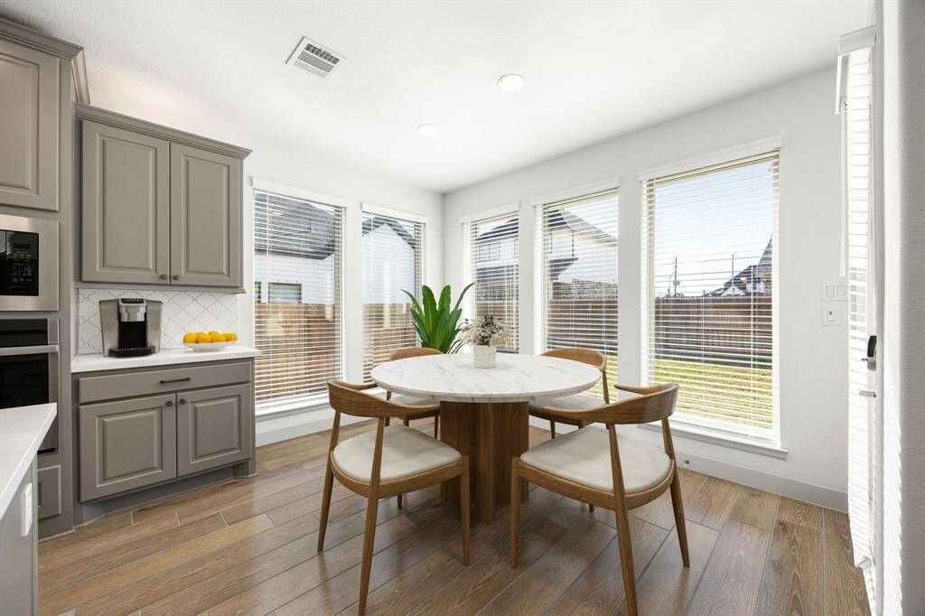 Start your day off right with a cup of coffee sitting with your family in the lovely breakfast area! Featuring large windows, custom neutral paint, tile flooring, recessed lighting and high ceilings.