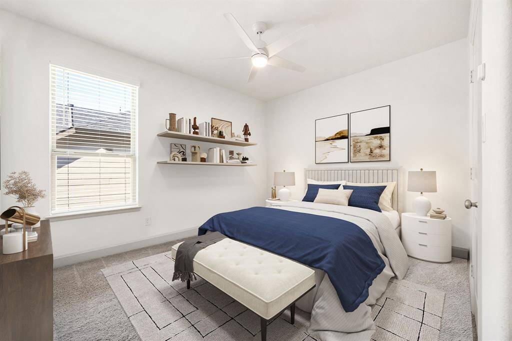 Secondary bedroom great for use as an in-law suite or guest suite features high ceilings, lovely modern ceiling fan, custom paint, plush carpet, space for seating area, direct access to the secondary bathroom and large window with privacy blinds. *Virtually Staged