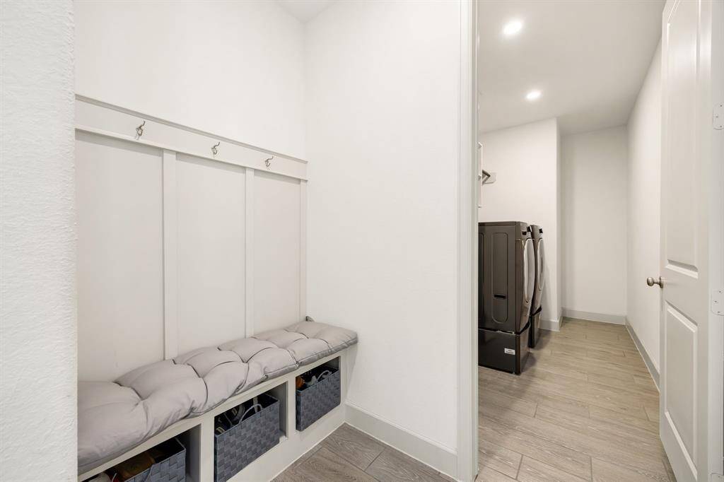 Practical mudroom nook with built-in storage and direct access to a modern laundry room, ensuring effortless organization.