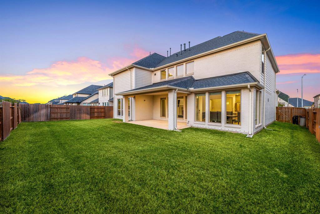 Spacious backyard ideal for entertaining, complete with a covered patio and an impressive two-story rear elevation.