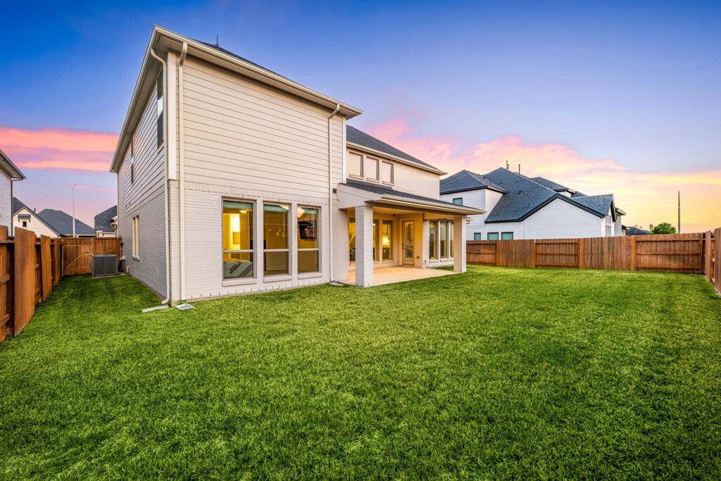 Another angle of the home’s large, fenced backyard—perfect for hosting gatherings or simply enjoying the sunset.