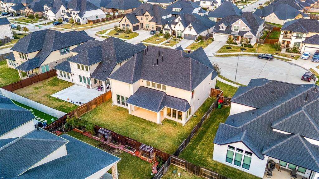 Breathtaking aerial perspective showcasing the home’s generous backyard, covered patio, and prime cul-de-sac location.