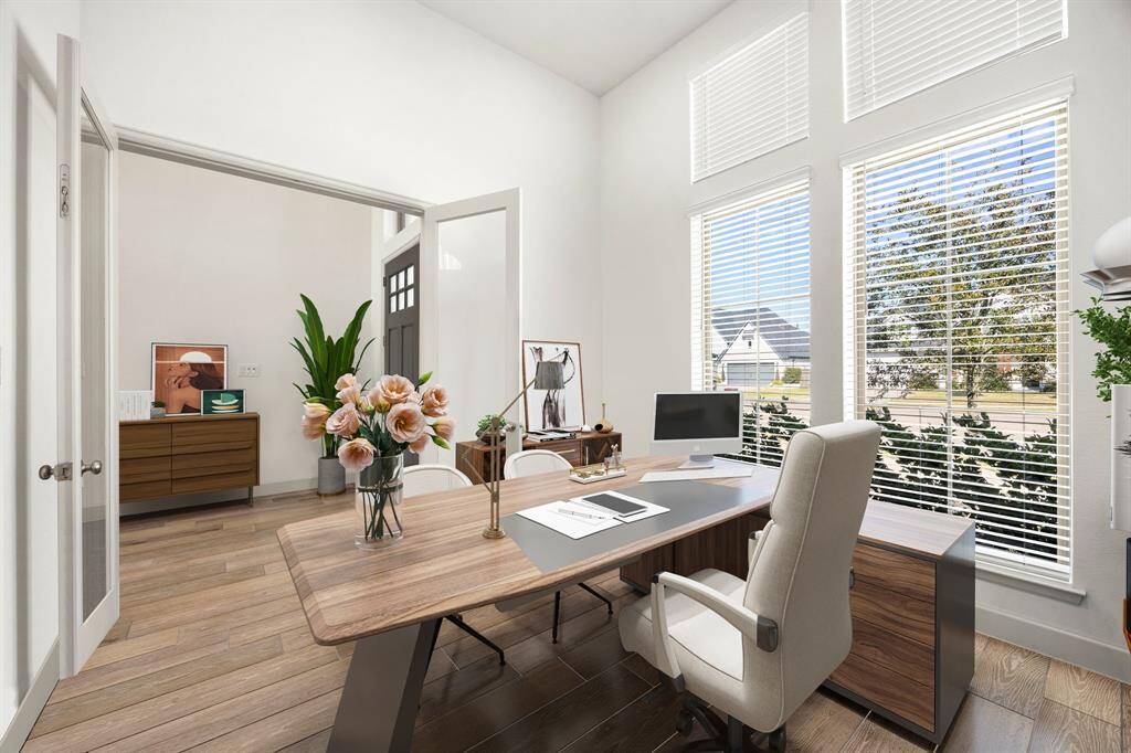 Bright and inviting home office featuring soaring ceilings, double doors, and expansive windows—ideal for remote work or studying in a sunlit space. *Virtually Staged