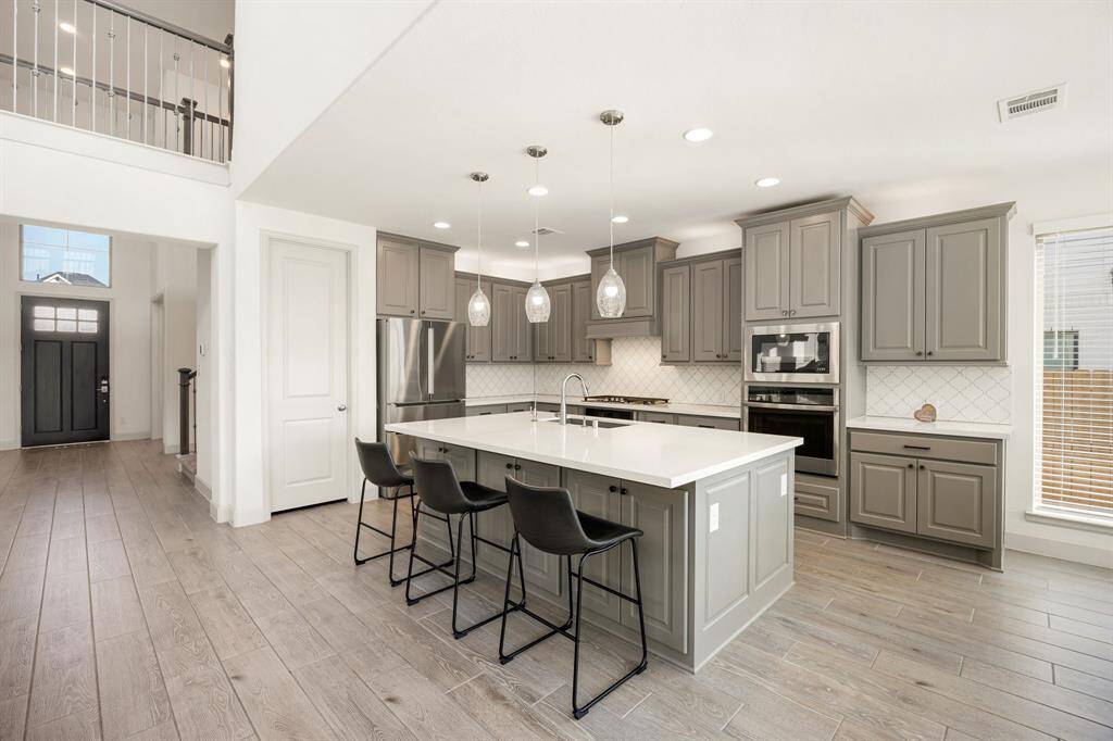 Any chef's dream, this stunning kitchen is perfect for everyday life as well as entertaining family and friends! Extra large kitchen island is perfect for conversation or that much needed space to lay out your party spread for everyone to enjoy! Large windows provide lovely views of your backyard and plenty of natural lighting throughout the day.