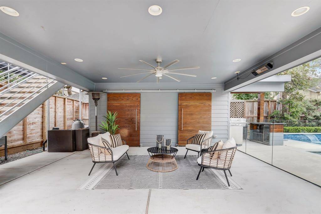 This carport also works well as an extended patio space that is perfect for lounging or dining al-fresco. Behind the sliding doors is extra storage space.