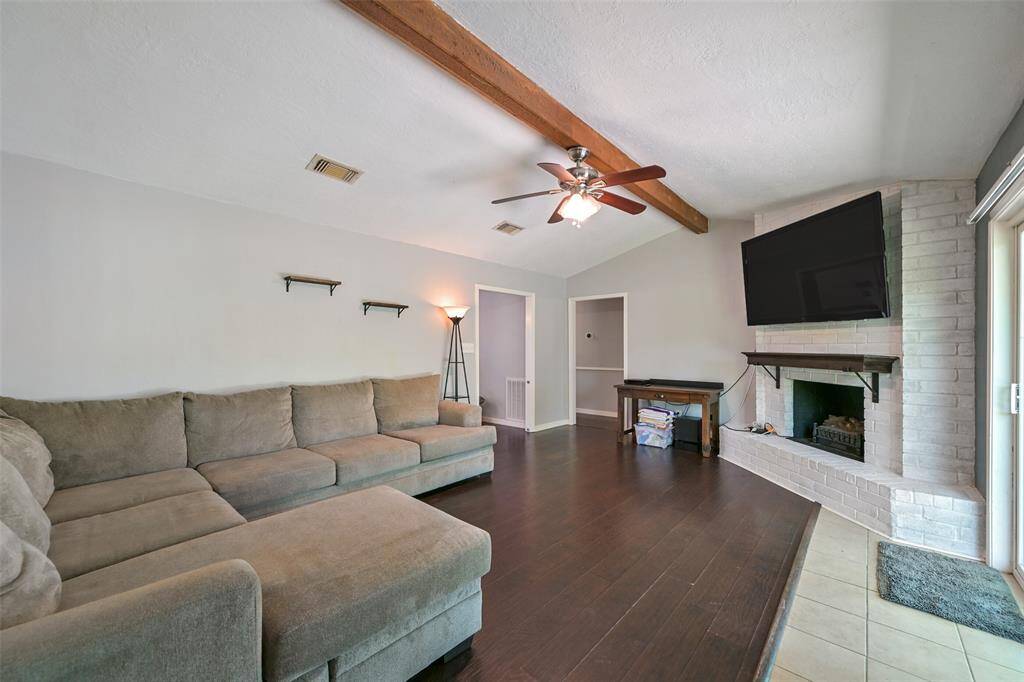 Formal living has a raised ceiling with wooden beam and fireplace!