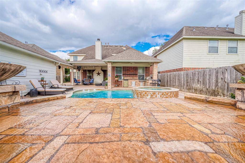 Look at this beautiful patio surrounding this gorgeous pool!