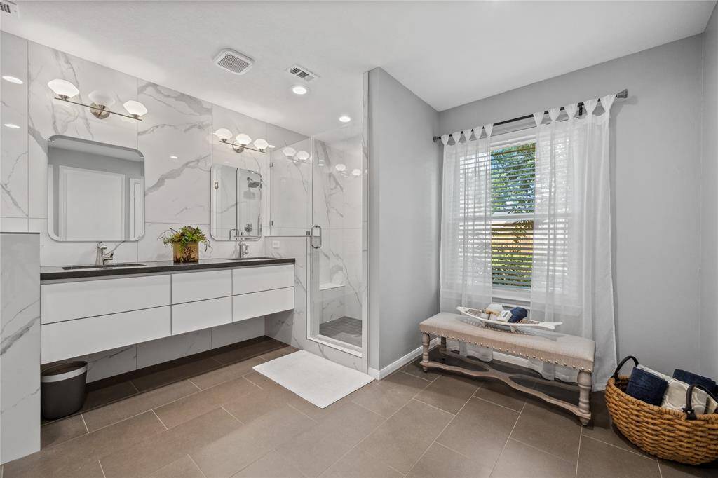 Updated Primary Bath Suite... Seller removed the tub (connections are still there by the bench... A Great space for a treadmill or exercise equipment...