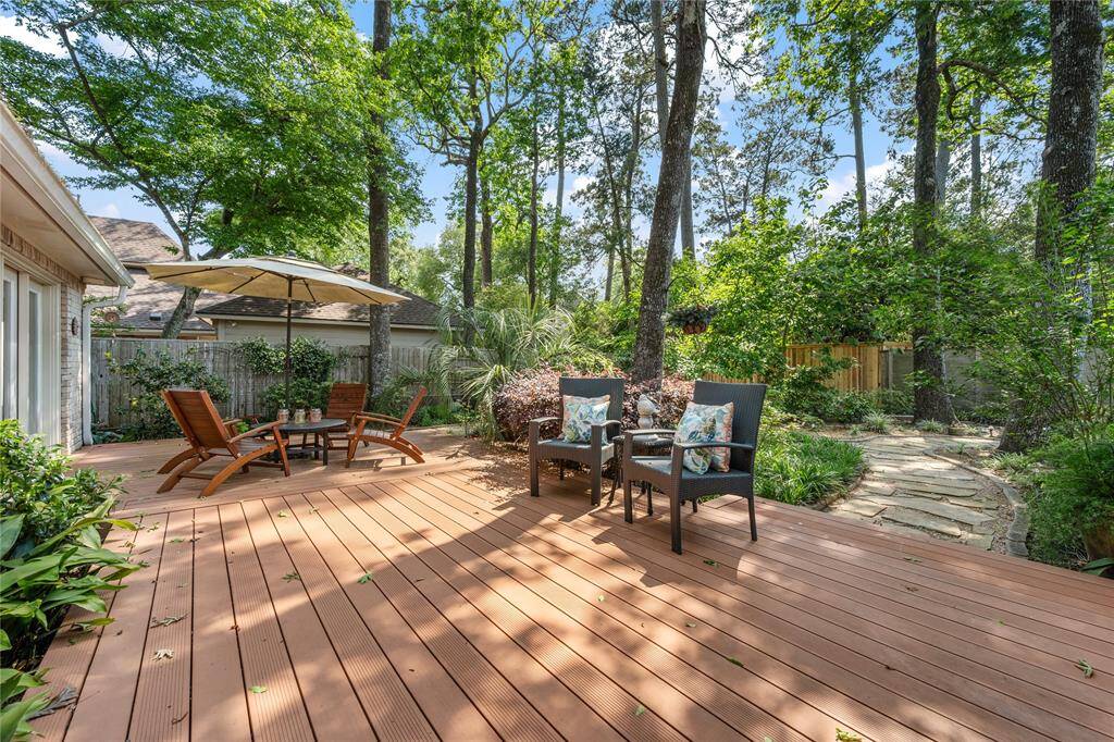 And... check out this Gorgeous back yard... with wood deck.... paths...flowers...