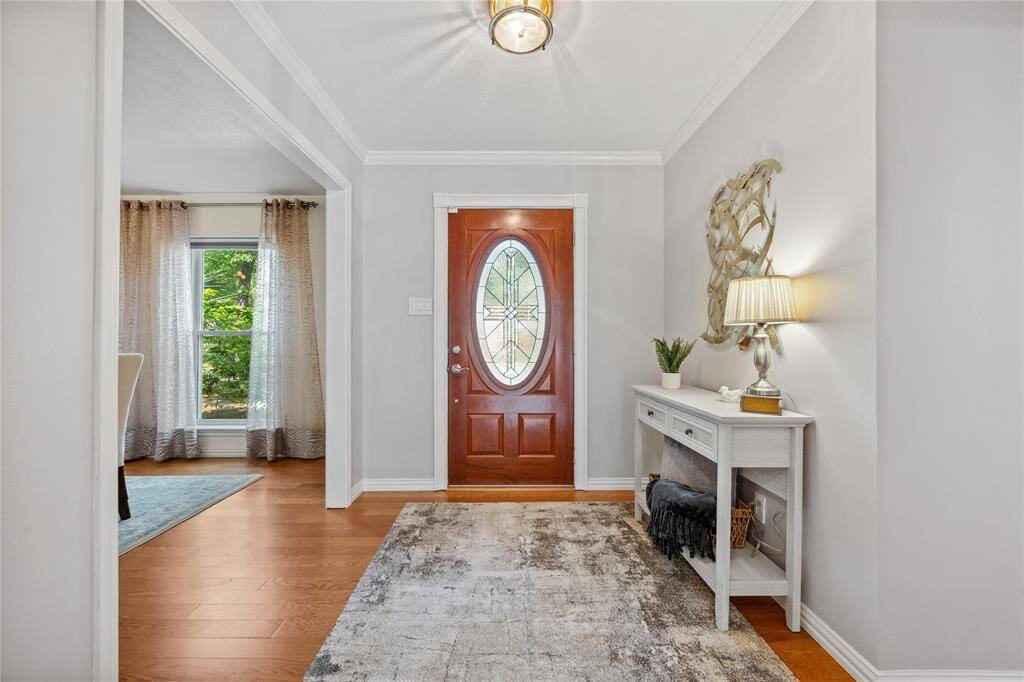 Large Foyer.... Impressive Wood floors-ALL ROOMS (except for kitchen, Bathroom areas...) Crown molding...A VERY PRETTY Entrance to YOUR HOME!!!