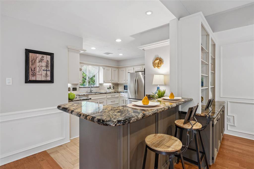 A Close up view of this Beautiful Granite... note the Granite also on the attached Cabinetry and Shelving... sooo Pretty! Soooo Classic!