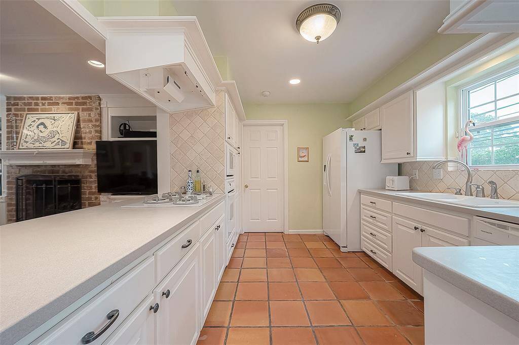 Kitchen open to family room next to utility room.