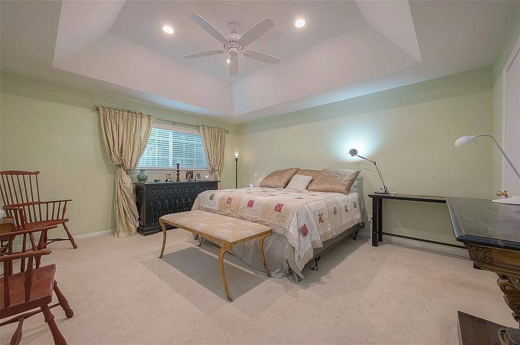 Primary bedroom with vaulted ceiling