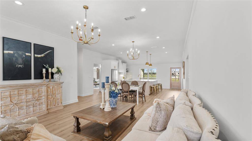 Features include recessed lighting, crown molding, and a lighting fixture that matches the dining area. There is plenty of room for your large sectional or loveseat and occasional chairs.