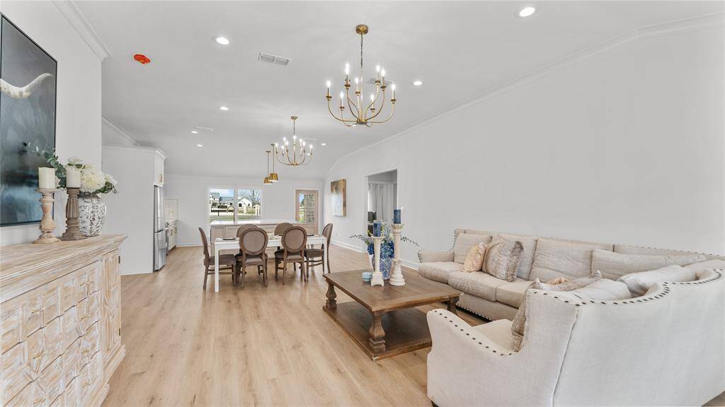 The fabulous room allows forcreativity to blossom in order tocreate the perfect space suitable foryour family. This is where family andfriends can come together, wherememories are made and shared. Take note of the gorgeous floors, recessed lighting, and stunning chandeliers.