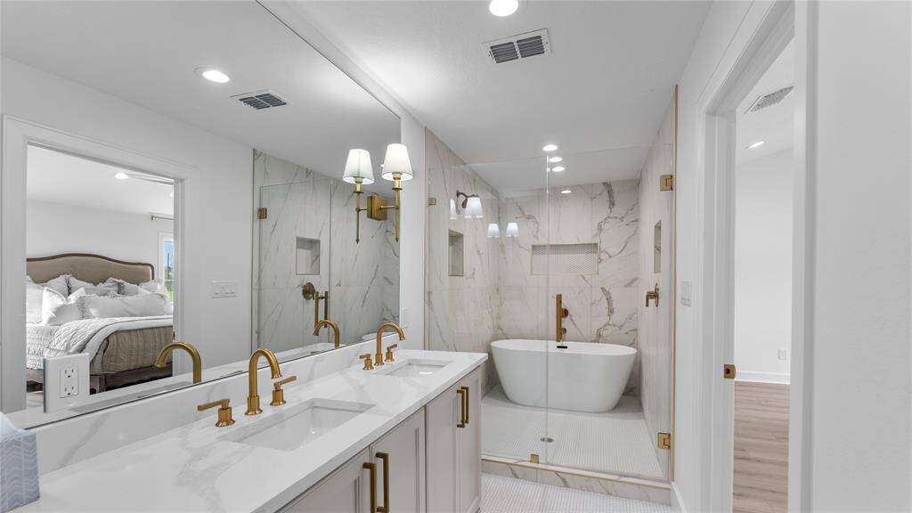 Large, frameless glass panels enclose the dual purpose shower and bathing area, creating a sense of openness and transparency while also preventing water from splashing outside the enclosure. Whether you prefer a quick, invigorating shower or a leisurely soak in the tub, this walk-in shower with a bathtub offers a luxurious and versatile retreat where you can indulge in the ultimate bathing experience.