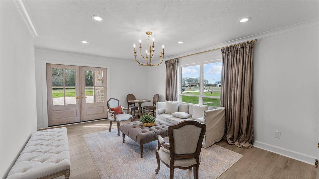 Welcome to the bonus room—a versatile space that offers endless possibilities for relaxation, entertainment, and creativity. Features include neutral floors, recessed lighting, crown molding, and a gorgeous lighting fixture that catches your eye. The double doors lead you to your side porch!