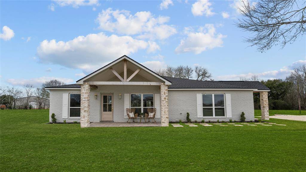 As you approach the home on your extended driveway, you're greeted by a charming front porch, perfect for enjoying your morning coffee or watching the sunset. The exterior features a fresh coat of paint, gorgeous stone wrapped pillars, and updated landscaping that adds to the country charm.