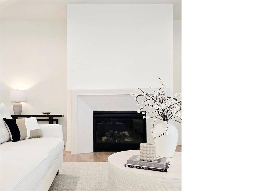 This custom plaster fireplace beautifully complements the home's organic textures and white oak floors.