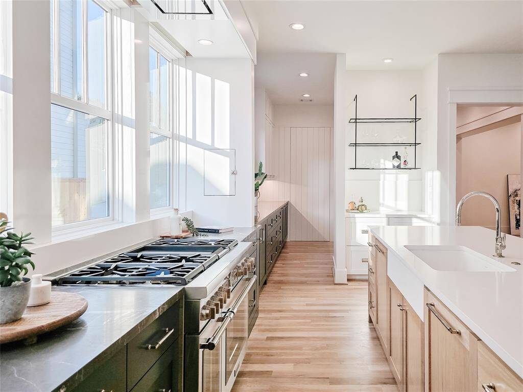 Experience a bright, beautifully designed kitchen that seamlessly extends into your own personal scullery.