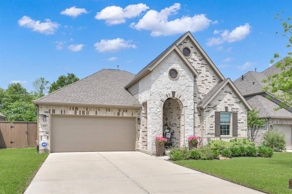 Featuring a two-car garage and well-maintained landscaping.