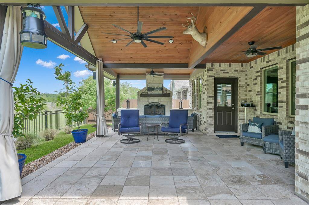 The 600 sf covered custom patio offers a  cozy stone fireplace, perfect for the winter months.