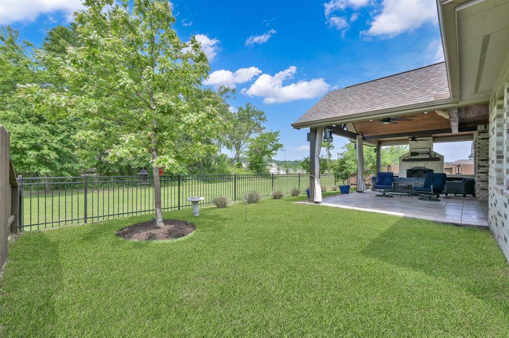 Burr oak tree, vitex purple ornamental tree and pink muhly grass compliment the backyard making a perfect space to relax.