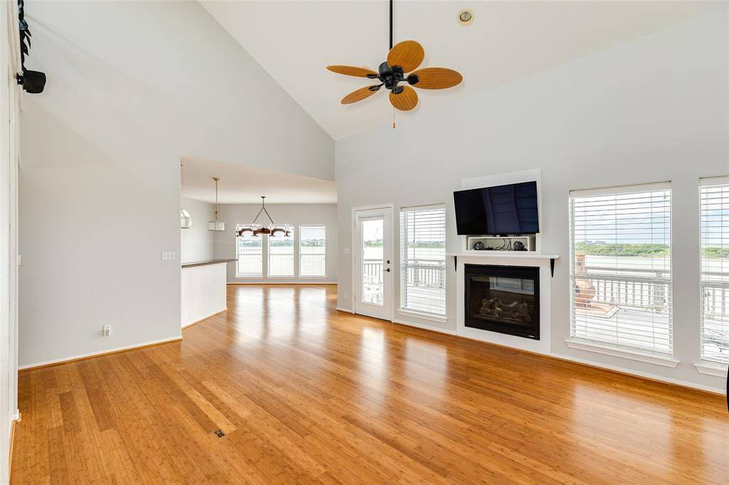 Livingroom with electric fireplace and the wall of windows