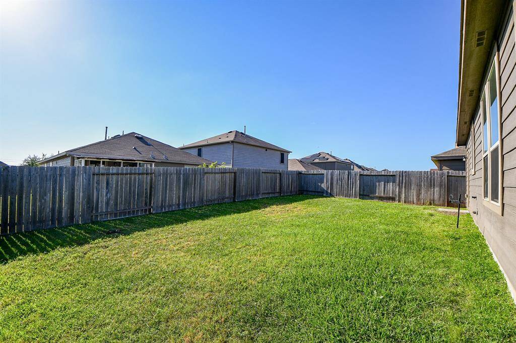 Step outside and envision the possibilities in this spacious backyard, an excellent extension of your future home.