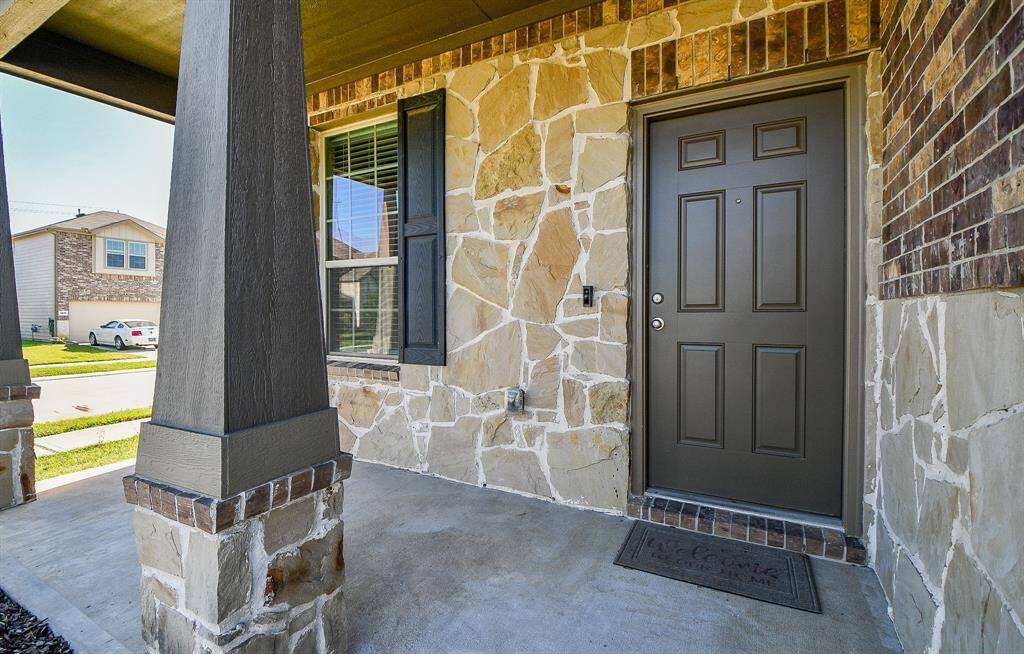 This charming entryway and covered porch hint at the beauty and quality that awaits within.