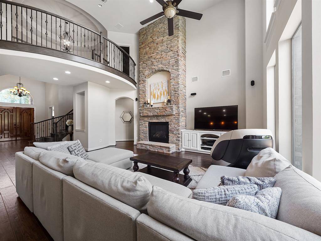 The second-story balcony overlooks the living room, adding architectural interest and a sense of grandeur.