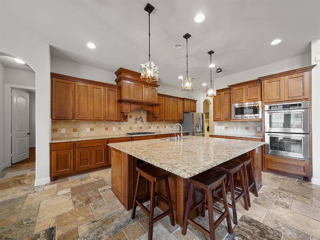 Welcome to your dream kitchen! This stunning culinary space boasts a gourmet island, gleaming granite countertops, and a stylish tile backsplash. Abundant counter and cabinet space ensures effortless meal preparation and storage.