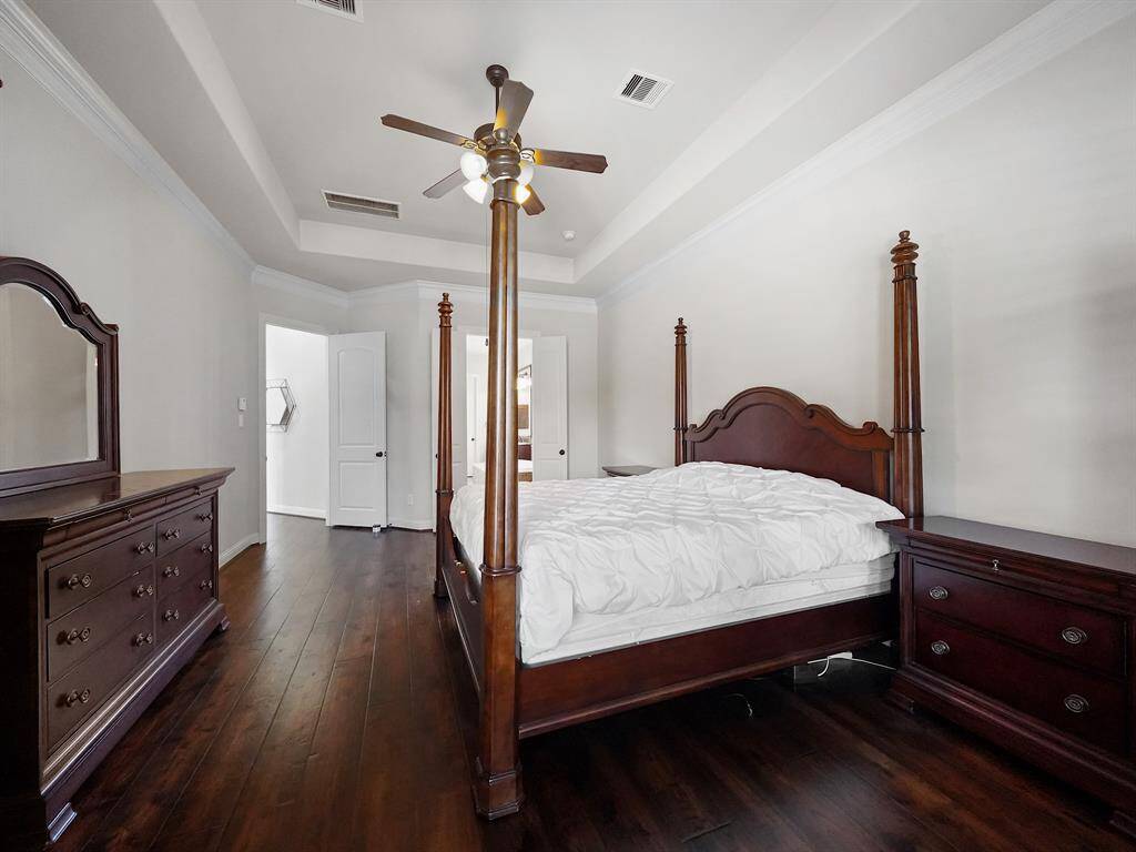 Alternative view of the primary retreat showcasing the entry to the ensuite bathroom.