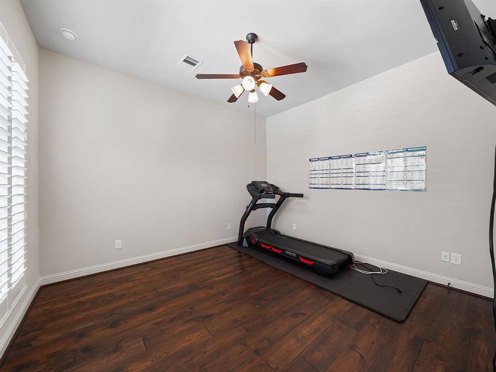 Downstairs secondary bedroom boasts a private ensuite, creating the perfect guest suite or flexible space. Currently utilized as an exercise room, this room offers versatility to suit your needs.