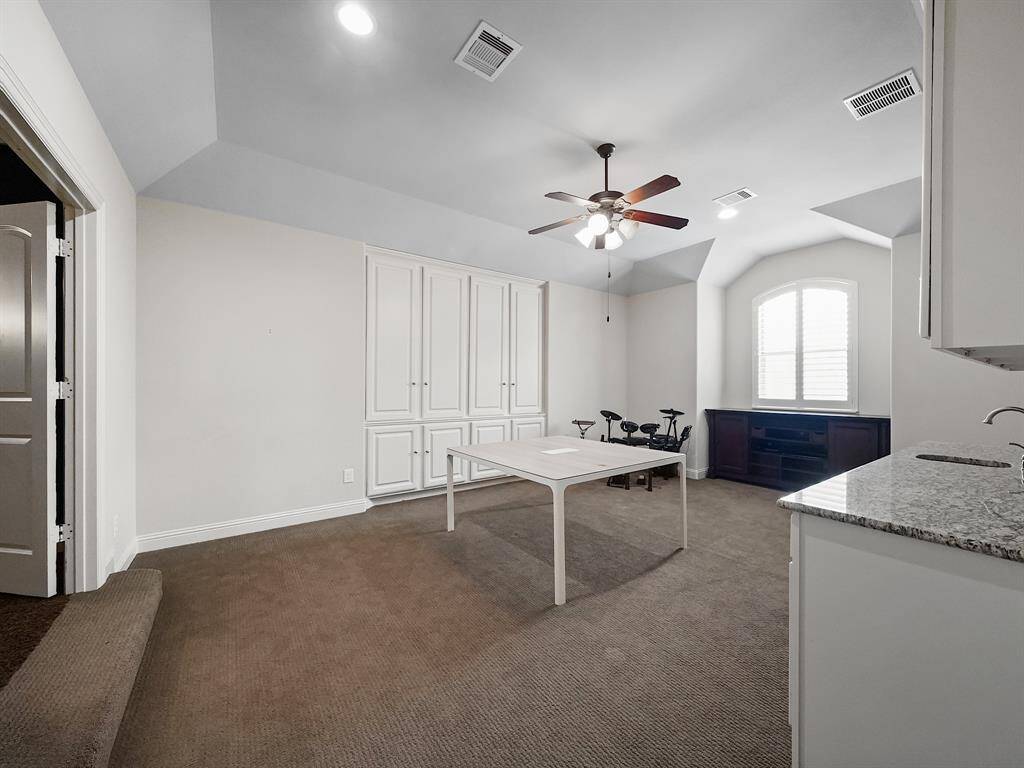 Nestled within this exceptional property lies a captivating second-floor game room, meticulously designed for both entertainment and functionality. Custom built-ins offer abundant storage solutions, ensuring a clutter-free environment. The expansive layout effortlessly accommodates a full-sized pool table, creating a versatile space for leisure and recreation.